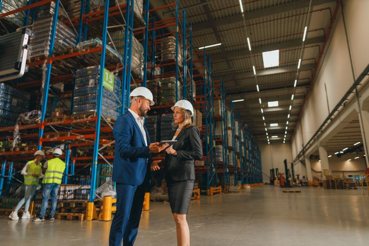 Warehouse colleagues working together around packaged goods